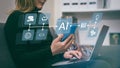A woman uses a laptop and smartphone, showcasing AI-powered cloud computing. Integration of technology in modern life, Royalty Free Stock Photo