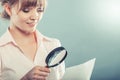 Woman uses magnifying glass to check contract Royalty Free Stock Photo