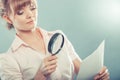 Woman uses magnifying glass to check contract Royalty Free Stock Photo