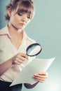 Woman uses magnifying glass to check contract Royalty Free Stock Photo