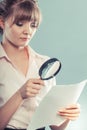 Woman uses magnifying glass to check contract Royalty Free Stock Photo