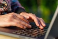 Woman uses a notebook computer outdoors close-up Royalty Free Stock Photo