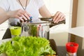 Woman uses pressure cooker to cook a meal.