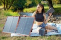 Woman uses solar panel to generate electricity for working on tablet pc Royalty Free Stock Photo