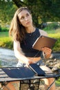 Woman uses solar panel to generate electricity for working on tablet pc outdoors Royalty Free Stock Photo