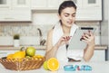 Woman Uses Tablet in Kitchen Royalty Free Stock Photo