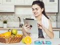 Woman Uses Tablet in Kitchen Royalty Free Stock Photo