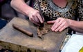 Woman uses tools to make handmaded cigars Royalty Free Stock Photo