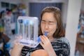 A woman uses a Tri-ball Incentive Spirometer for check his lung function Royalty Free Stock Photo