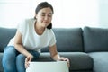 Woman using air purifier while living at home.