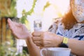 Woman using alcohol nano mist sprayer antiseptic cleaning on her hands protection during Coronavirus pandemic Covid-19.Hand using