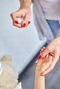 Woman using alcohol spray to little child girl. Royalty Free Stock Photo