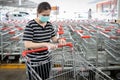 Woman using alcohol wet cloth,wipes the trolley handle with disinfecting cloth,cleaning the surface with disinfectant on shopping Royalty Free Stock Photo