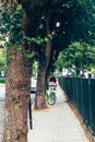 Woman is using an app in her smartphone to rent a Lime-E electronic bike in London Royalty Free Stock Photo