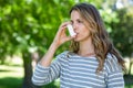 Woman using asthma inhaler Royalty Free Stock Photo