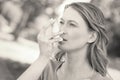 Woman using asthma inhaler in park Royalty Free Stock Photo