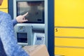 Woman using automated self service post terminal machine or lock Royalty Free Stock Photo