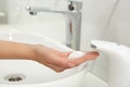 Woman using automatic soap dispenser in bathroom Royalty Free Stock Photo