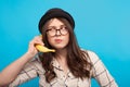 Woman using banana as phone