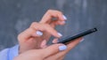 Woman using black smartphone with touchscreen display - close up side view