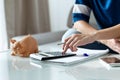 Woman using calculator and counting her savings while sitting on sofa at home Royalty Free Stock Photo