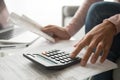 Woman using calculator holding bills planning expenses, close up view Royalty Free Stock Photo