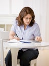 Woman using calculator to pay bills Royalty Free Stock Photo