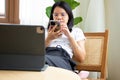 woman using cell phone in cafe and food