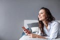 Woman using cellphone bed at home Royalty Free Stock Photo