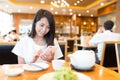 Woman using cellphone in chinese restaurant Royalty Free Stock Photo