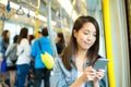 Woman using cellphone inside train compartment Royalty Free Stock Photo