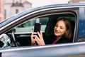 Young woman using cellphone to take photo inside a car Royalty Free Stock Photo