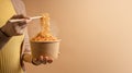 Woman Using Chopsticks to Eating Hot Boiled Instant Cup Noodles. Cheap Asian Fast food Concepts Royalty Free Stock Photo