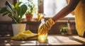 a woman using cleaning gloves, spray bottle and a yellow cloth to clean a kitchen countertop