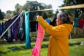 Woman Using Clothe Lines To Dry Clothes In an Energy Efficient Way Royalty Free Stock Photo