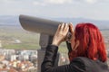 Woman using coin operated binoculars Royalty Free Stock Photo