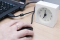 Woman using computer mouse with laptop and white clock on the table, Accelerate work concept Royalty Free Stock Photo