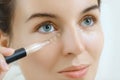 Woman using concealer for under eye circles Royalty Free Stock Photo
