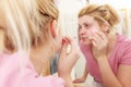 Woman using cotton pad to remove make up Royalty Free Stock Photo