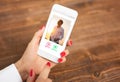 Woman using dating app and swiping user photos Royalty Free Stock Photo