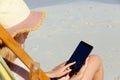 Woman using digital tablet at the beach Royalty Free Stock Photo