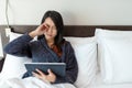 Woman using digital tablet and feeling eye pain Royalty Free Stock Photo