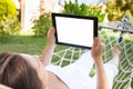 Woman using digital tablet in hammock at park Royalty Free Stock Photo