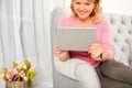 Woman using digital tablet while sitting in sofa Royalty Free Stock Photo