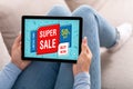 Woman Using Digital Tablet With Super Sale Screen