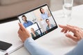 Woman Using Digital Tablet For Video Conference With Group Of Business People Royalty Free Stock Photo