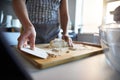 Woman using a dough scraper, making fresh dough at home