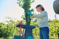 Woman using electric garden shredder for branches and bushes Royalty Free Stock Photo