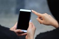 Woman using electronic gadget, typing message or checking newsfeed on social networks with her friend