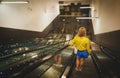 Woman using the escalator Royalty Free Stock Photo